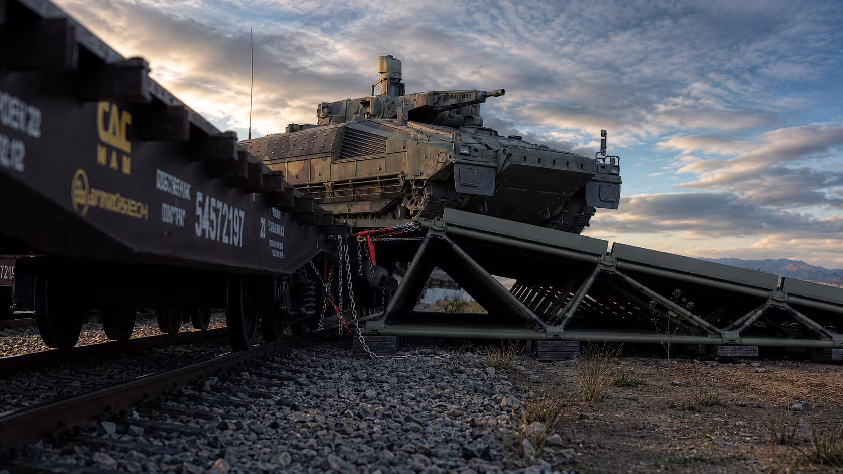 Tracked armored vehicle unloading from a railcar over an ER40 loading ramp at a railhead
