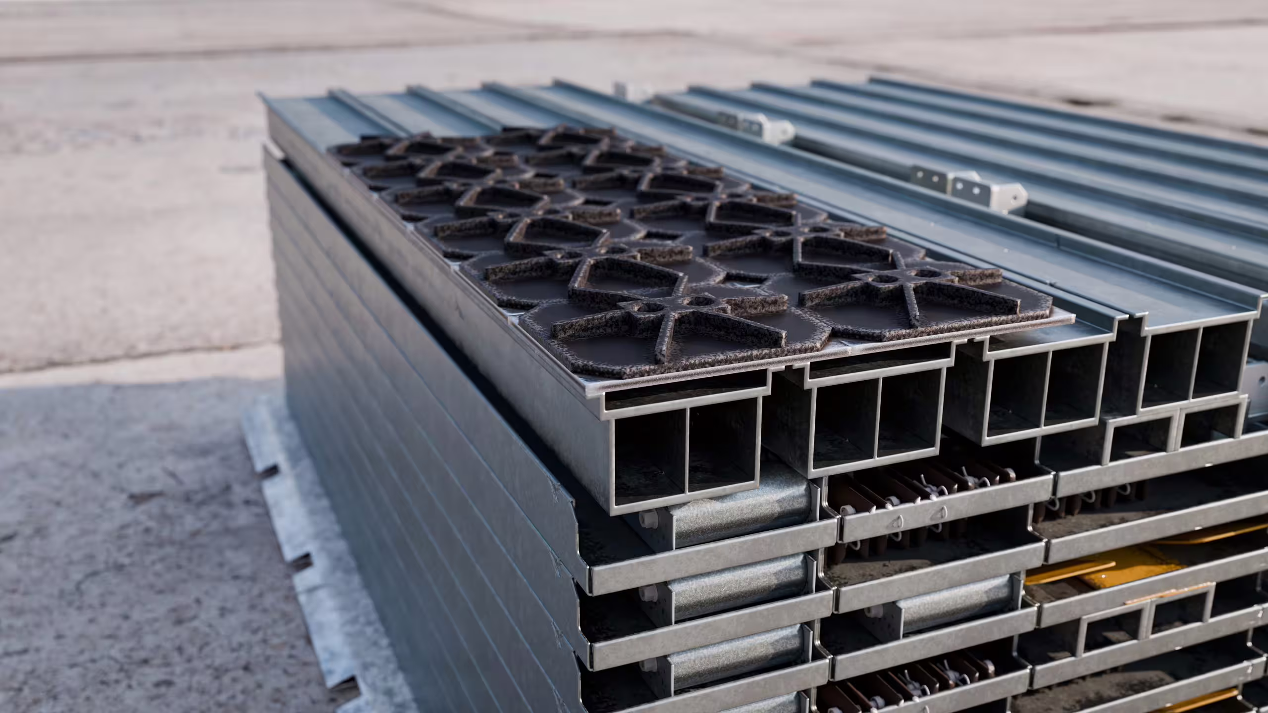 Air Cargo Dock sections flat-packed in a stack ready to move as cargo, box-section frames and anti-slip deck panels visible in cross-section
