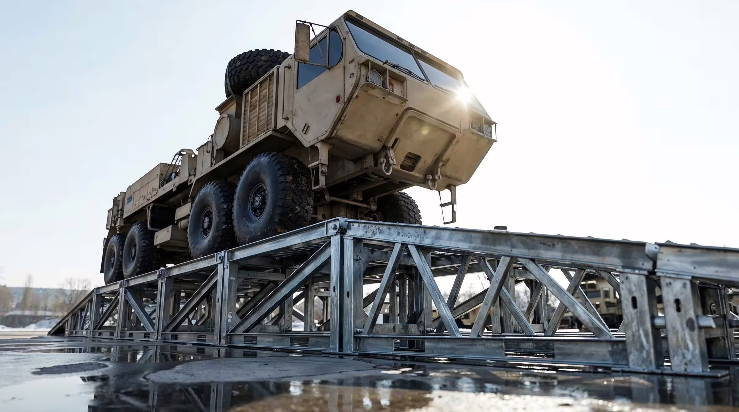 Eight-wheeled military truck on a MUDR-PD/WR steel wash and inspection ramp