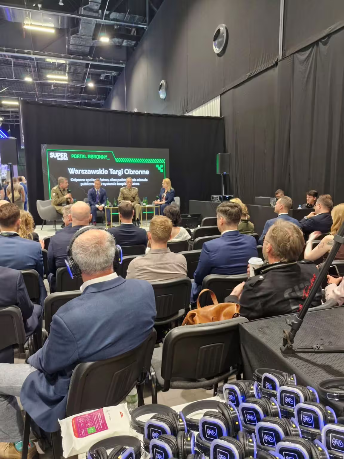 Panel discussion on public health in the security system at the Warsaw Defence Expo, with the audience seated in front of the stage.