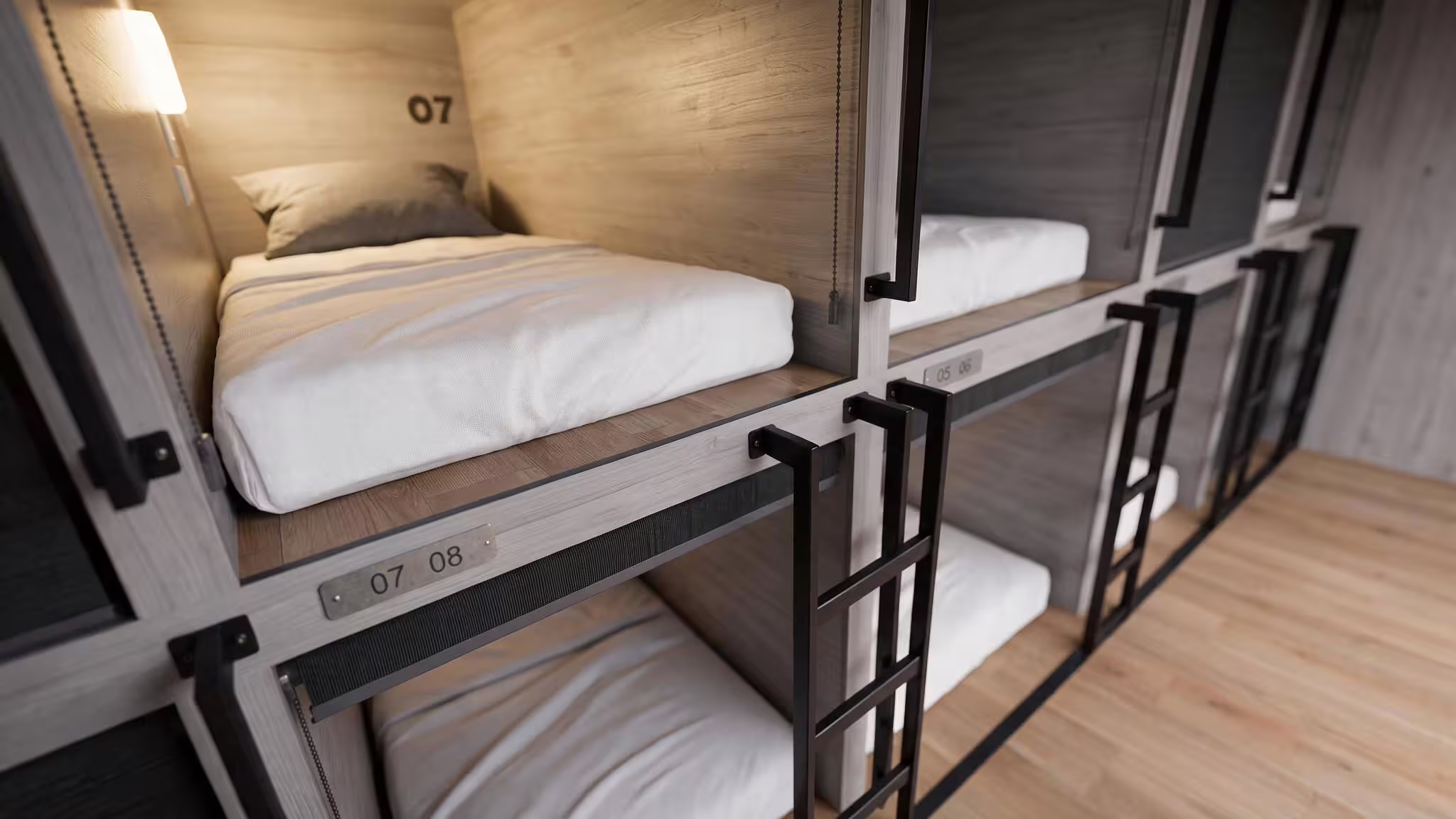 An upper berth inside a BunkBox pod, timber-lined with a fitted mattress, a steel ladder alongside and the berth numbers stamped on the frame