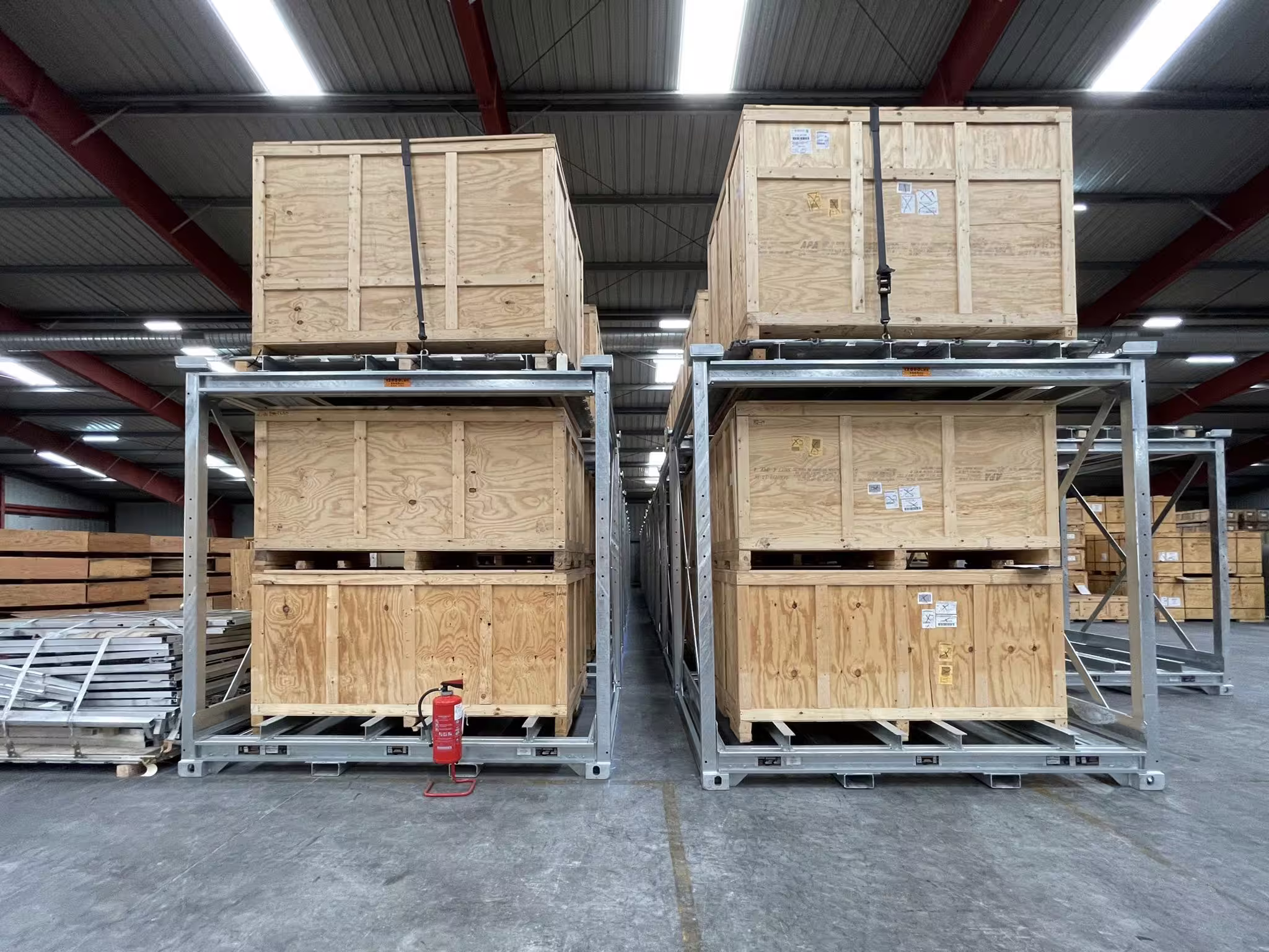 Two CargoCuber frames stacked two high in a warehouse bay, timber crates seated on both the upper and lower levels