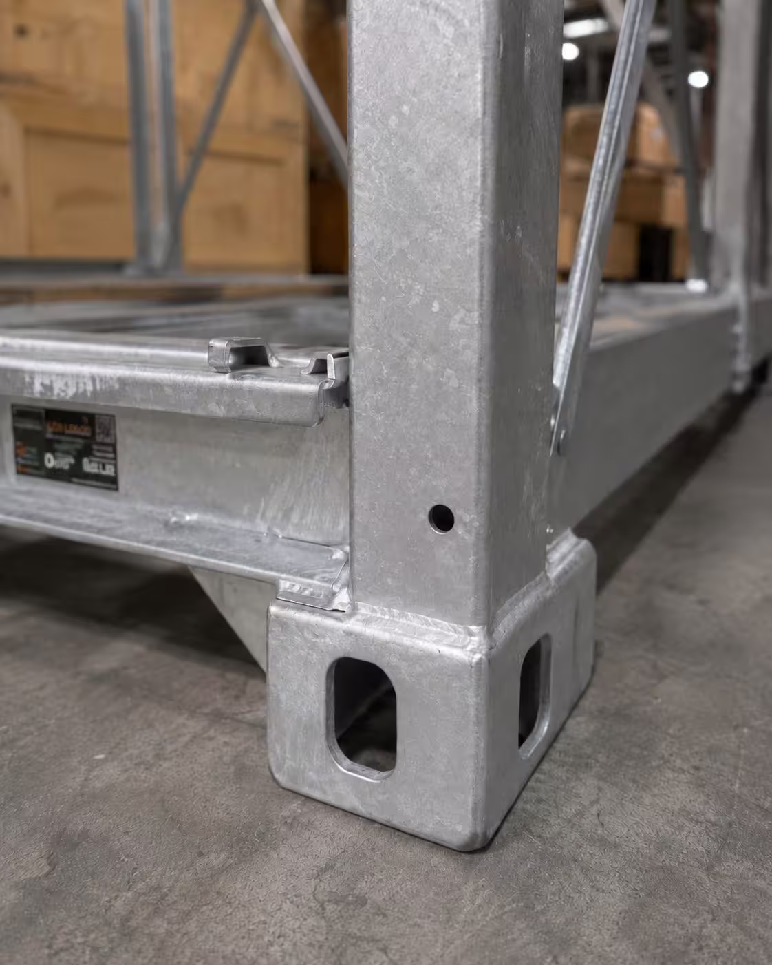 A close view of a CargoCuber corner casting, showing the twin location holes and the welded junction between the upright and the base rail