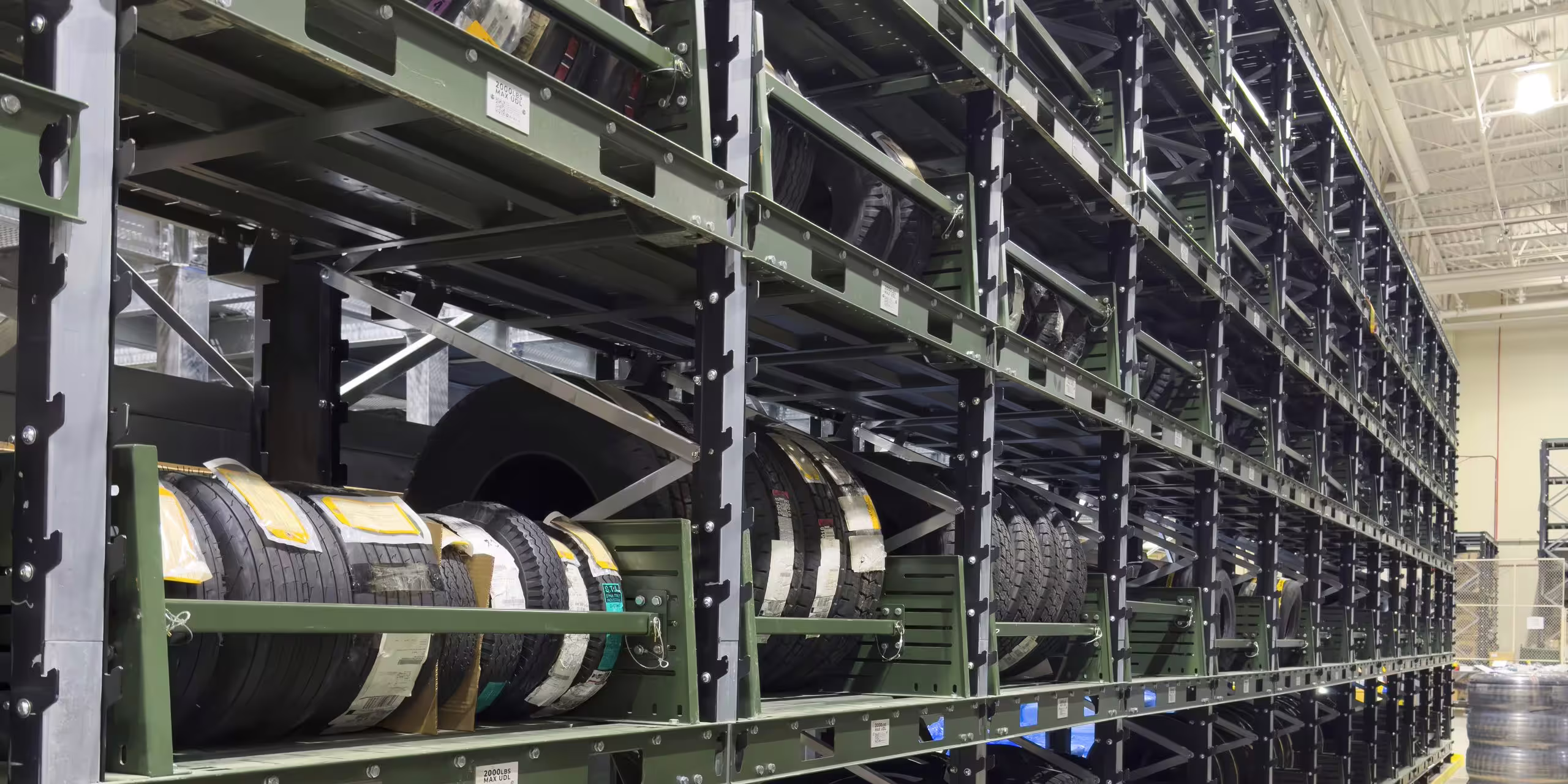 A rated-capacity plate fixed to an IARS upright, stating the permitted load per pallet position alongside the bay reference
