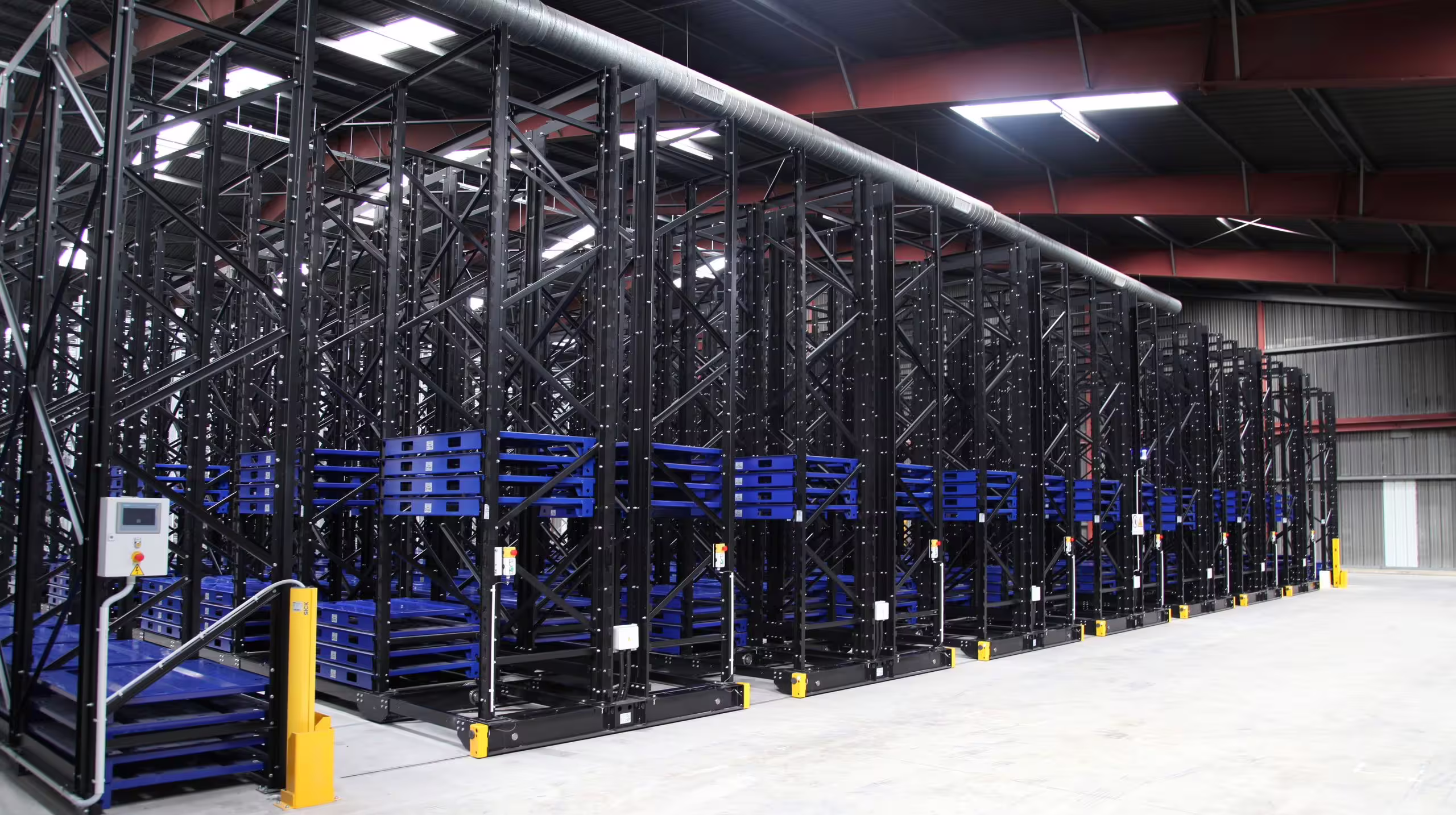 IARS mobile racking with its bays rolled closed against each other on the floor rails, the aisles between them eliminated so the stock occupies a continuous block