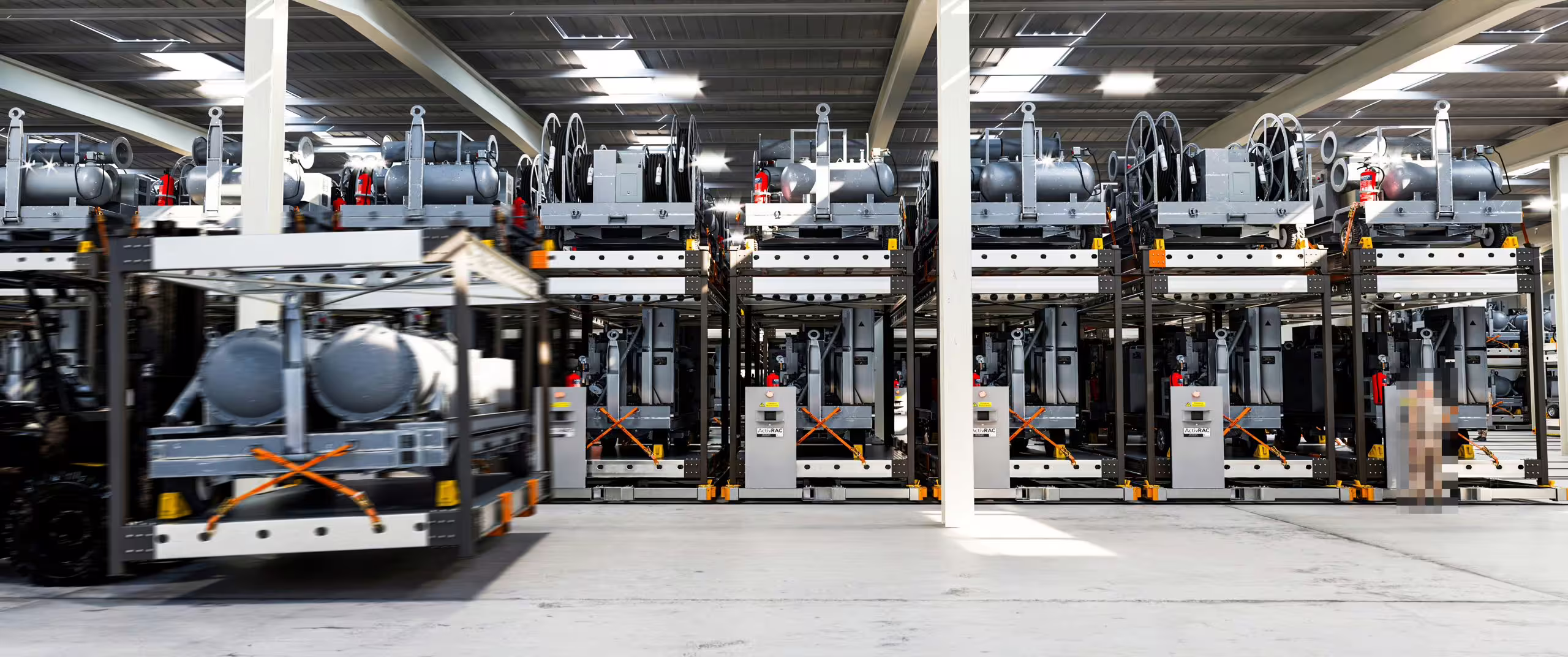 Wide render of a RollingStack installation, ranks of crates carrying wheeled plant and gas cylinders on two levels across a pillared hall